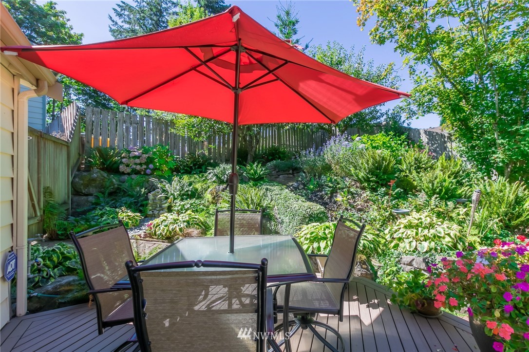 15612 Southeast 178th Street Renton, WA 98058 - Photo 9 of 40 a patio with a table and chairs under an umbrella
