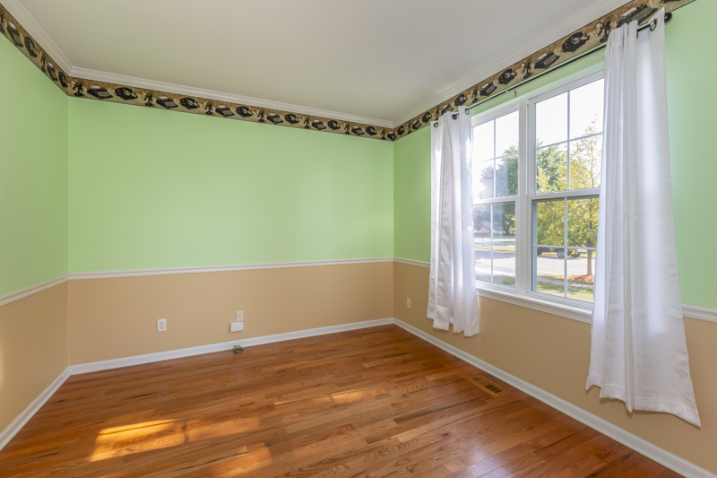 220 Stearn Drive Genoa, IL 60135 - Photo 17 of 42 a view of a big room with wooden floor and windows
