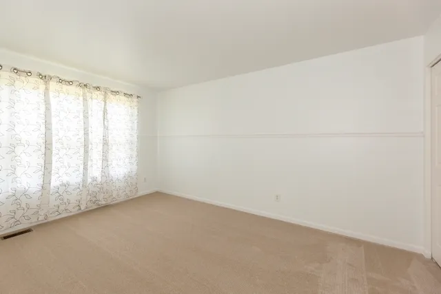 a white toilet sitting next to a bath tub