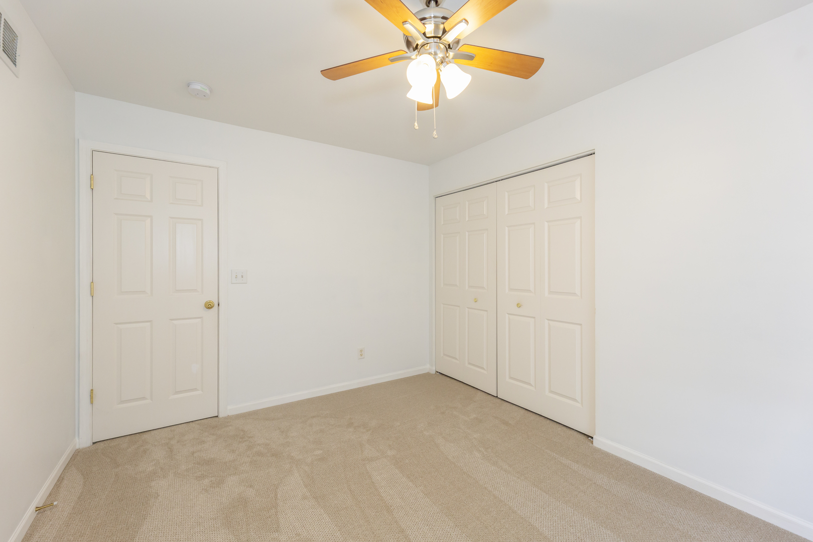 220 Stearn Drive Genoa, IL 60135 - Photo 34 of 42 an empty room with windows and fan