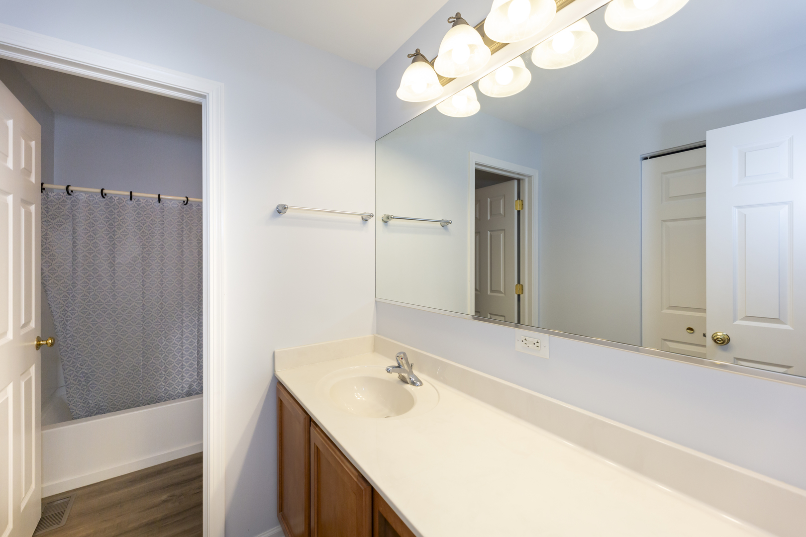 220 Stearn Drive Genoa, IL 60135 - Photo 35 of 42 a bathroom with a sink a mirror and a shower