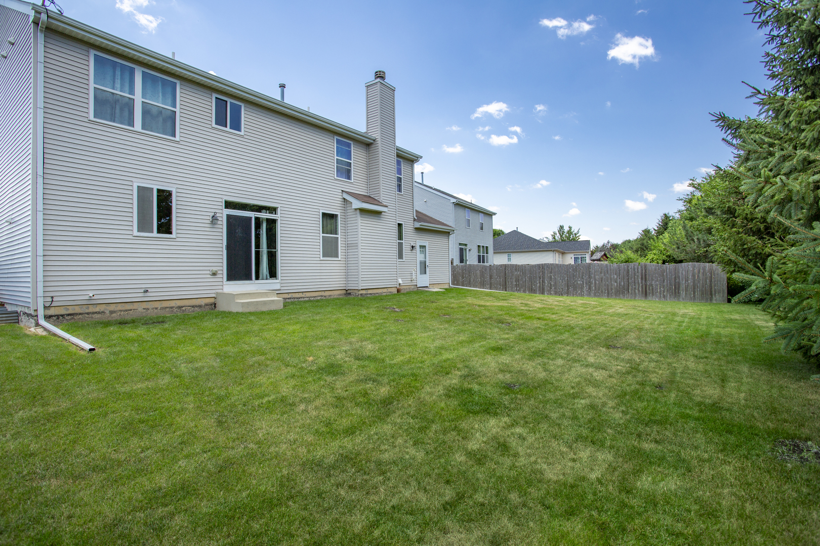 220 Stearn Drive Genoa, IL 60135 - Photo 42 of 42 a backyard of a house with lots of green space