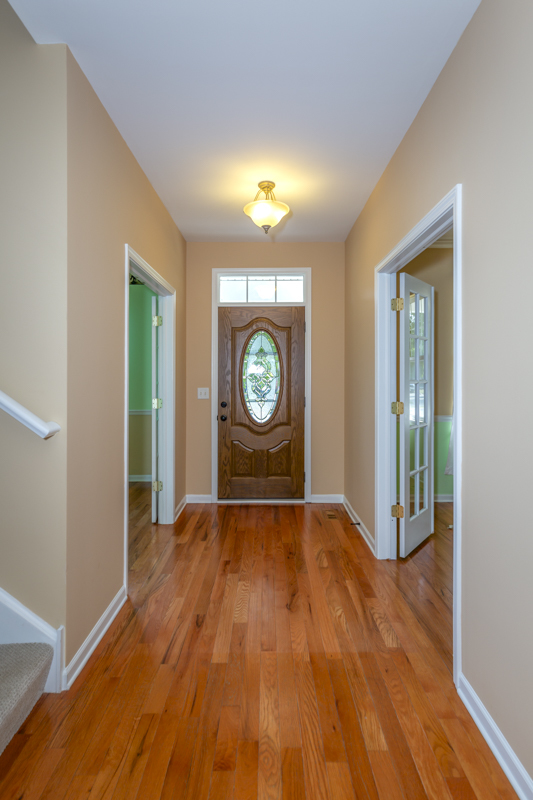 220 Stearn Drive Genoa, IL 60135 - Photo 6 of 42 a view of an empty room with window and wooden floor
