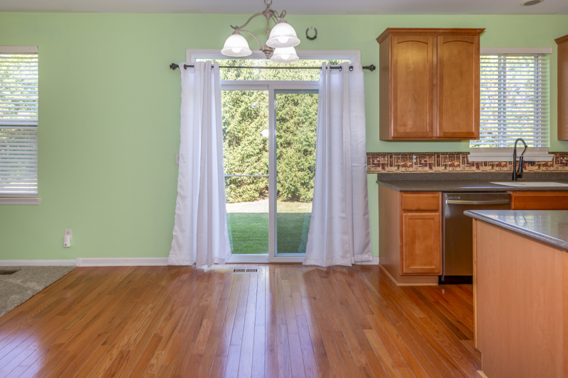 220 Stearn Drive Genoa, IL 60135 - Photo 10 of 42 a view of a kitchen with wooden floor and a window