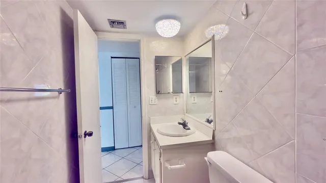 a large kitchen with stainless steel appliances granite countertop a table chairs in it and wooden floors