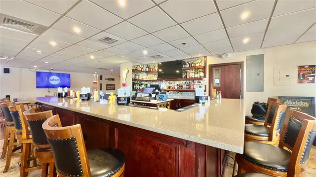 a large bedroom with bed and wooden floor