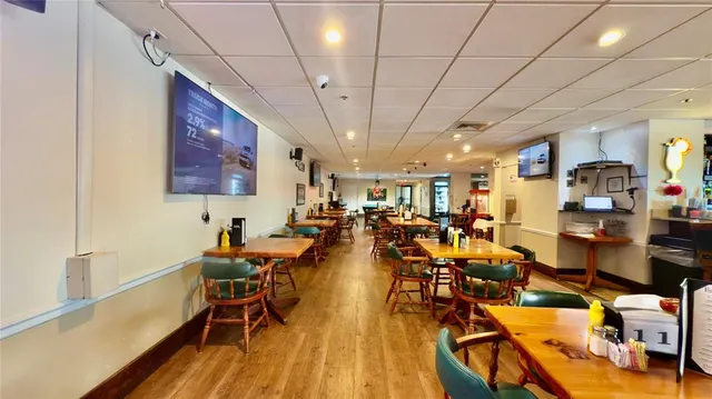 a living room with furniture and a book shelf