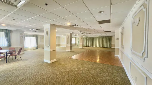 a swimming pool with outdoor seating and a patio