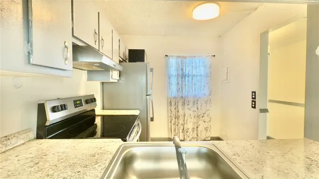 a bathroom with a granite countertop sink a toilet and a shower