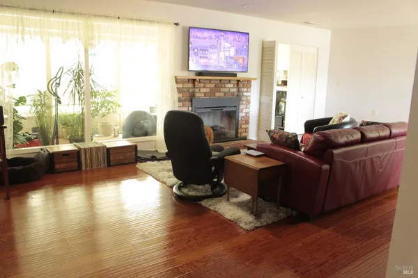 a living room with furniture window and a wooden floor
