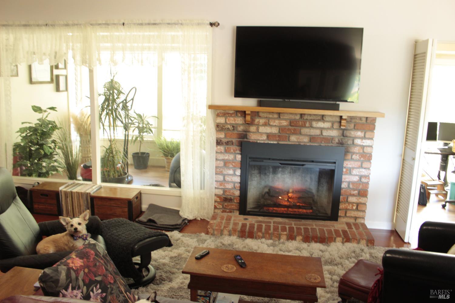 11 Oakgreen Santa Rosa, CA 95409 - Photo 13 of 37 a living room with furniture and a flat screen tv