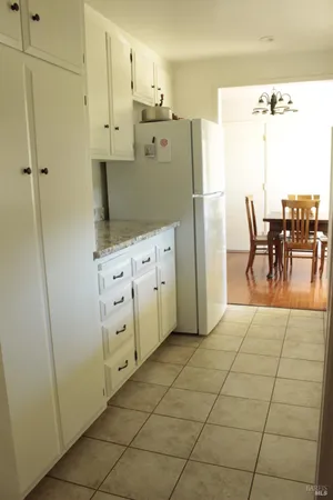 a kitchen with stainless steel appliances a refrigerator sink and cabinets