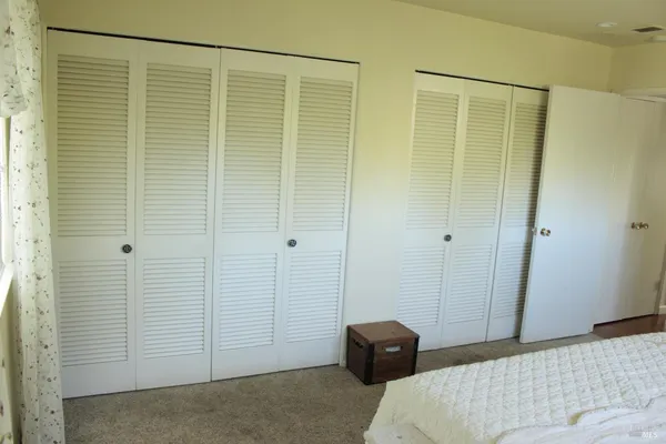 a bedroom with a bed and a shower