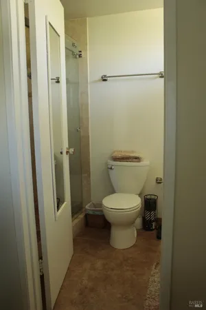 a bathroom with a toilet and a shower