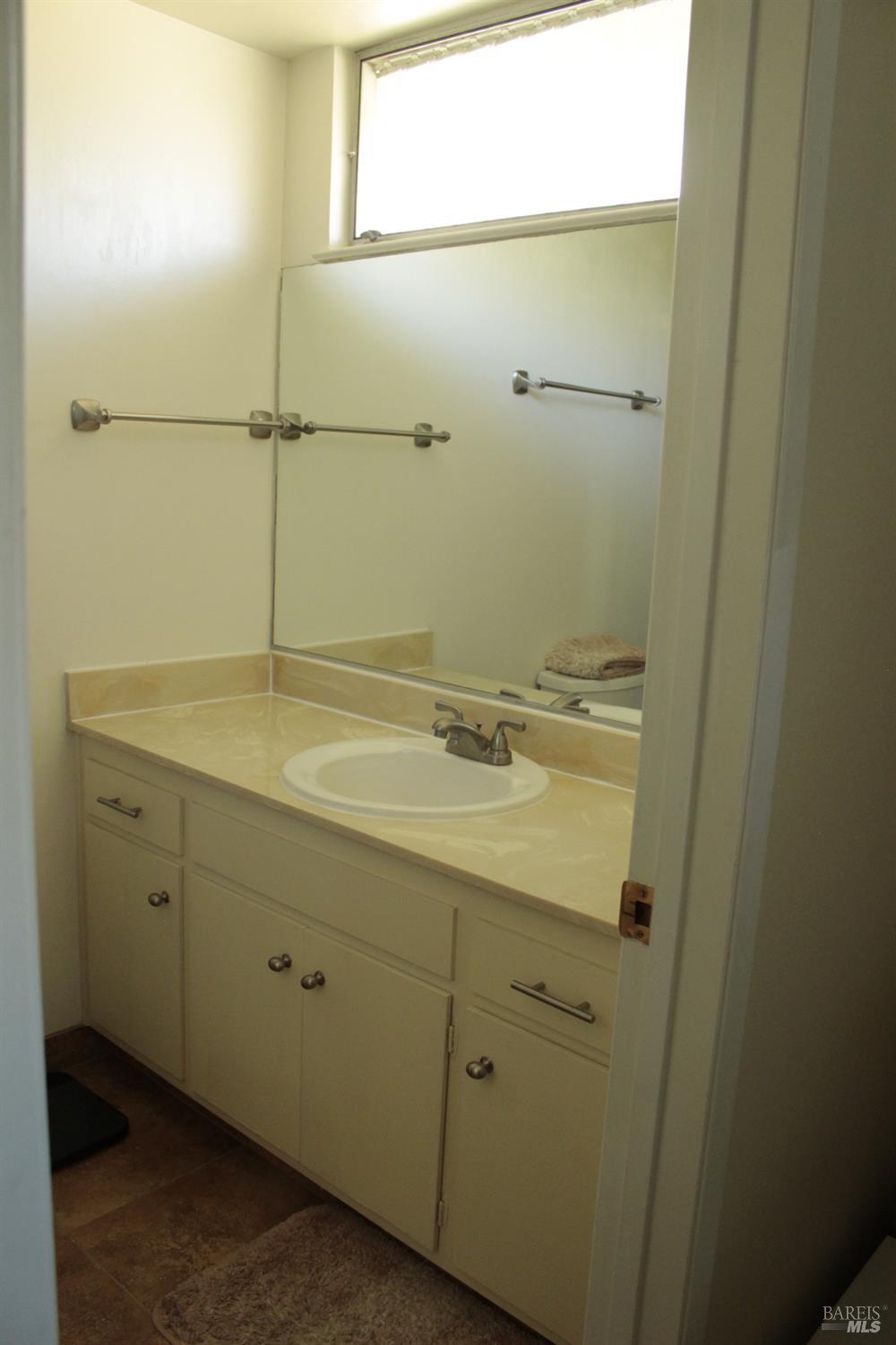 11 Oakgreen Santa Rosa, CA 95409 - Photo 25 of 37 a bathroom with a sink and mirror