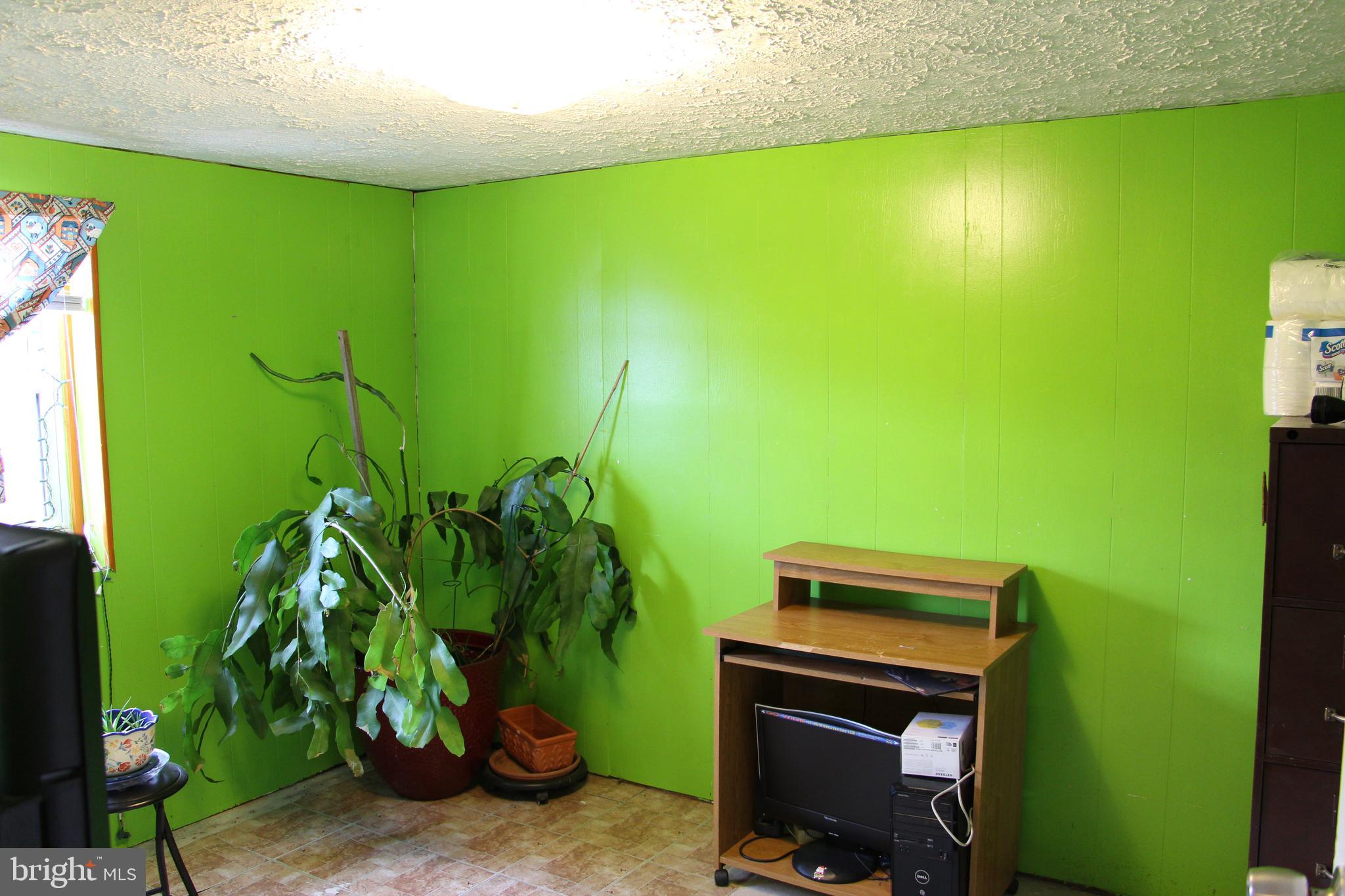 775 Corners Road Cabins, WV 26855 - Photo 18 of 20 a backyard of a house with plants and a wooden fence