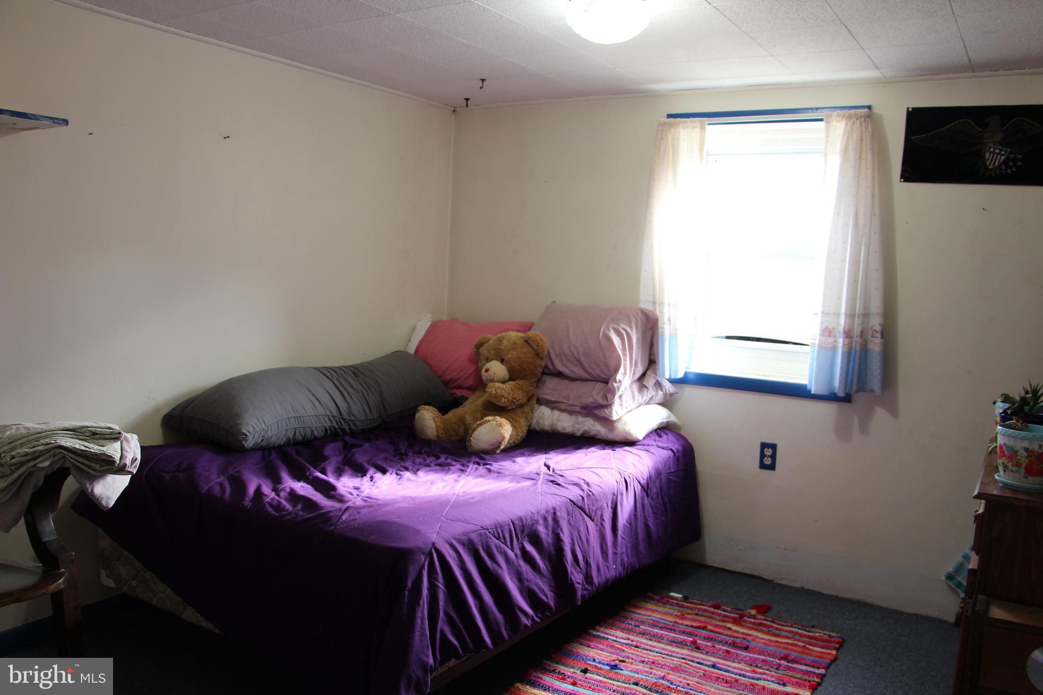 775 Corners Road Cabins, WV 26855 - Photo 19 of 20 a bedroom with a bed and wooden floor
