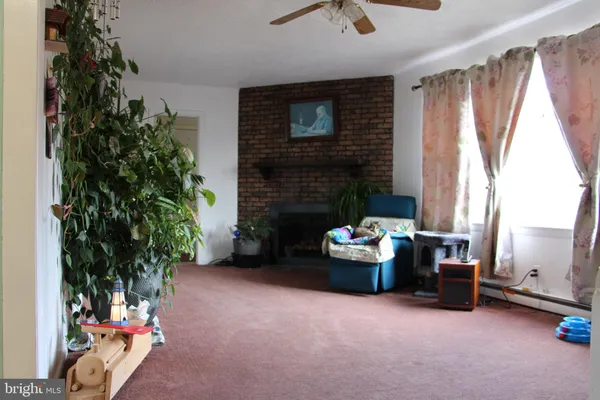 a living room with furniture and a fireplace