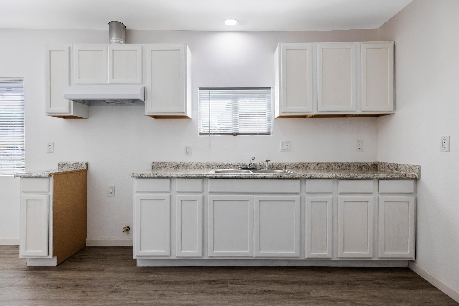 23375 Ave 196 Strathmore, CA 93267 - Photo 11 of 31 a kitchen with granite countertop white cabinets and sink
