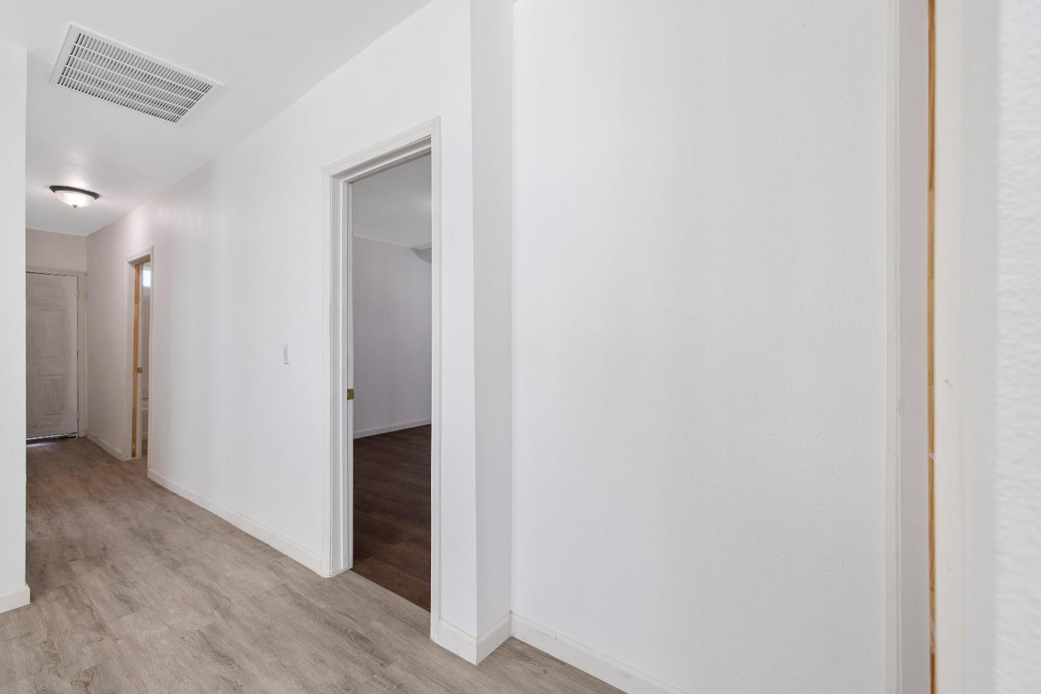 23375 Ave 196 Strathmore, CA 93267 - Photo 13 of 31 a view of hallway with closet and wooden floor