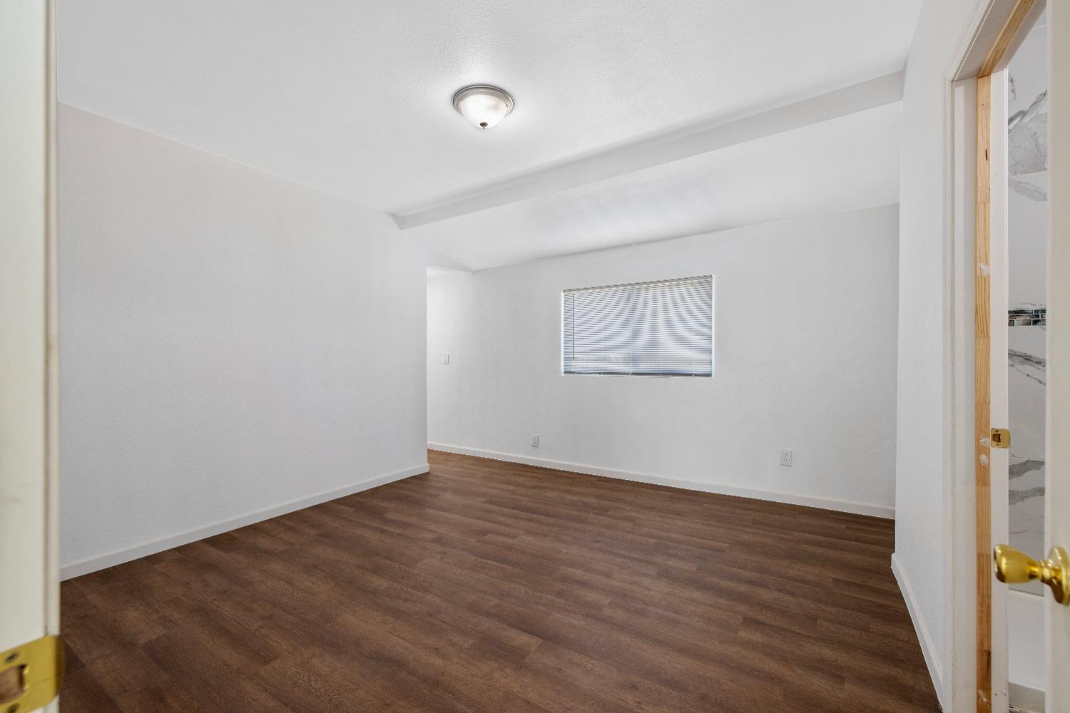 23375 Ave 196 Strathmore, CA 93267 - Photo 15 of 31 an empty room with wooden floor and windows