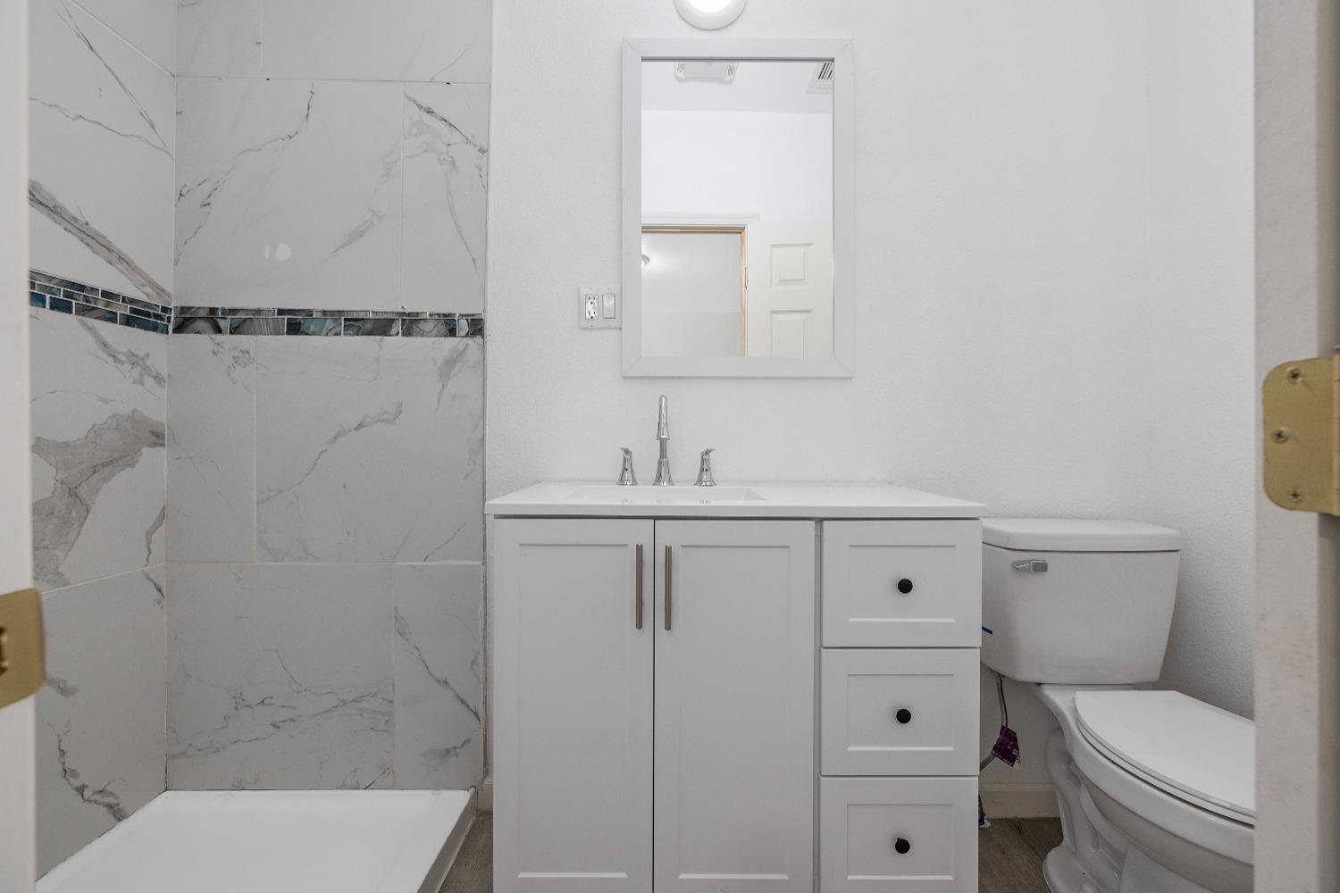 23375 Ave 196 Strathmore, CA 93267 - Photo 18 of 31 a bathroom with a sink toilet vanity and shower