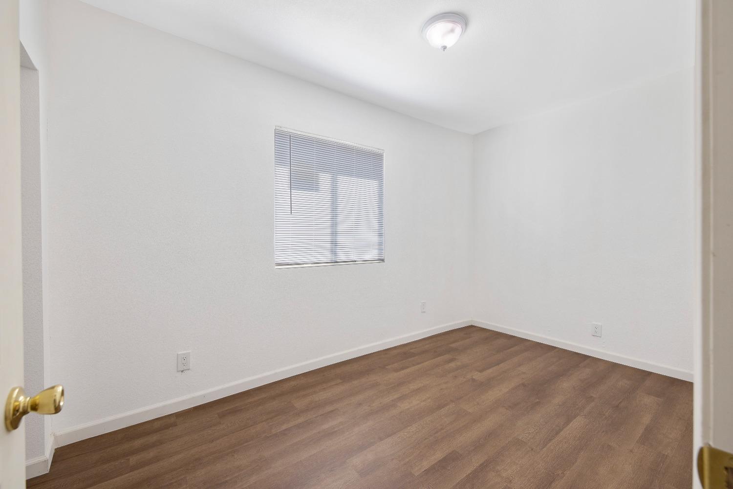23375 Ave 196 Strathmore, CA 93267 - Photo 20 of 31 an empty room with wooden floor and windows