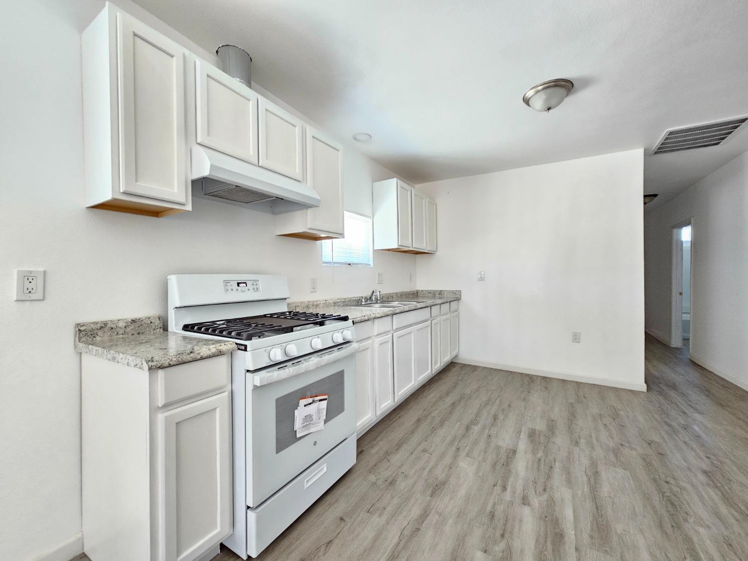 23375 Ave 196 Strathmore, CA 93267 - Photo 10 of 31 a kitchen with stainless steel appliances granite countertop a stove and a white cabinets