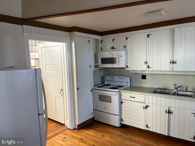 3200 Main Street, Unit 1 Morgantown, PA 19543 - Photo 2 of 9 a kitchen with white cabinets and white appliances