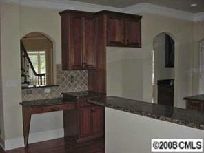 3206 Williams Road Matthews, NC 28105 - Photo 3 of 7 a kitchen with granite countertop wooden cabinets and granite counter tops