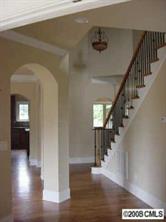 3206 Williams Road Matthews, NC 28105 - Photo 4 of 7 a view of a hallway with wooden floor stairs and a living room