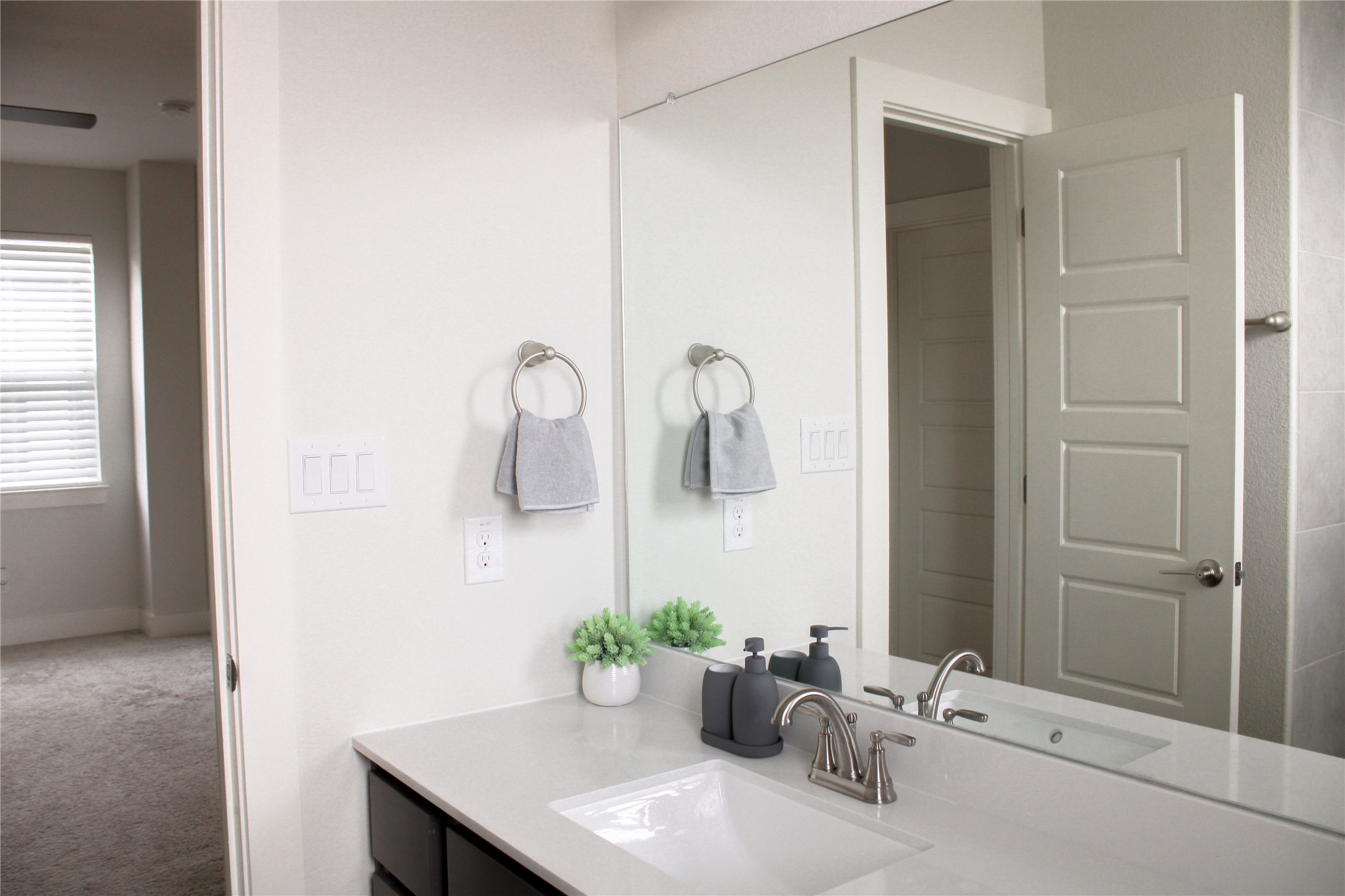 1007 Harwell Loop Kyle, TX 78640 - Photo 27 of 40 a bathroom with a sink and mirror