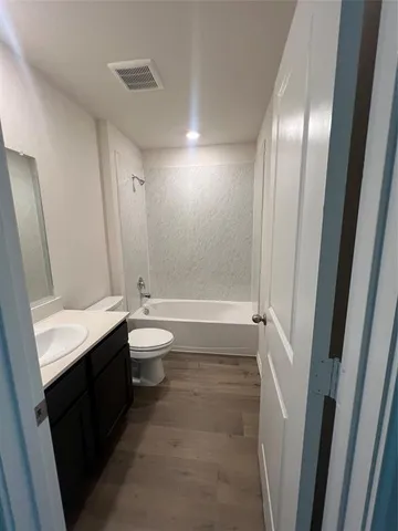 a bathroom with a double vanity sink toilet and shower