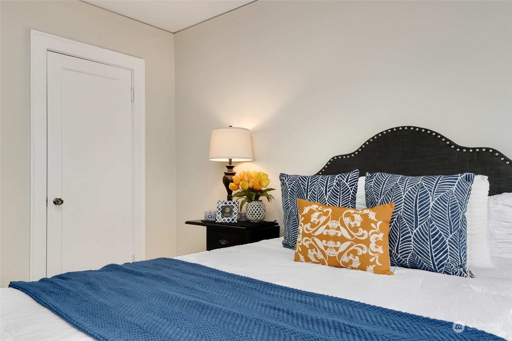 1605 East Olive Street, Unit 307 Seattle, WA 98122 - Photo 13 of 21 a bedroom with a bed and wooden floor