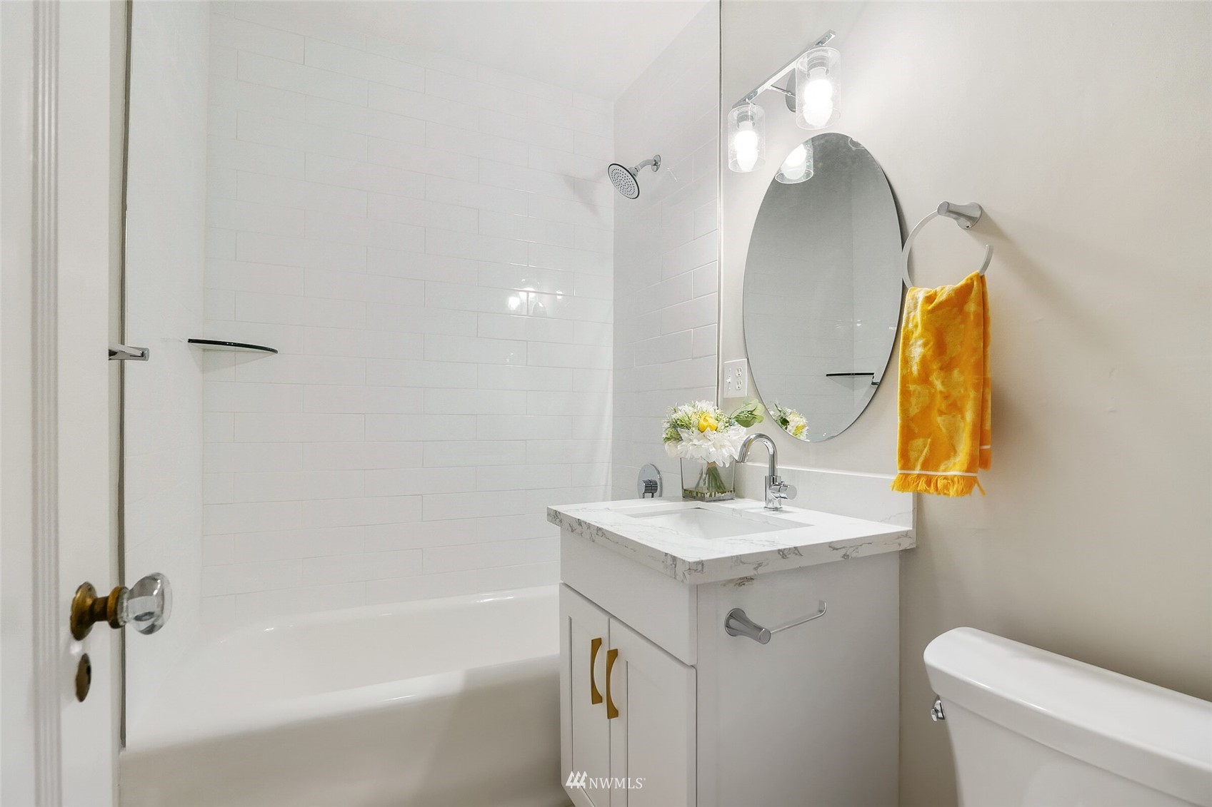 1605 East Olive Street, Unit 307 Seattle, WA 98122 - Photo 14 of 21 a bathroom with a sink vanity mirror and toilet