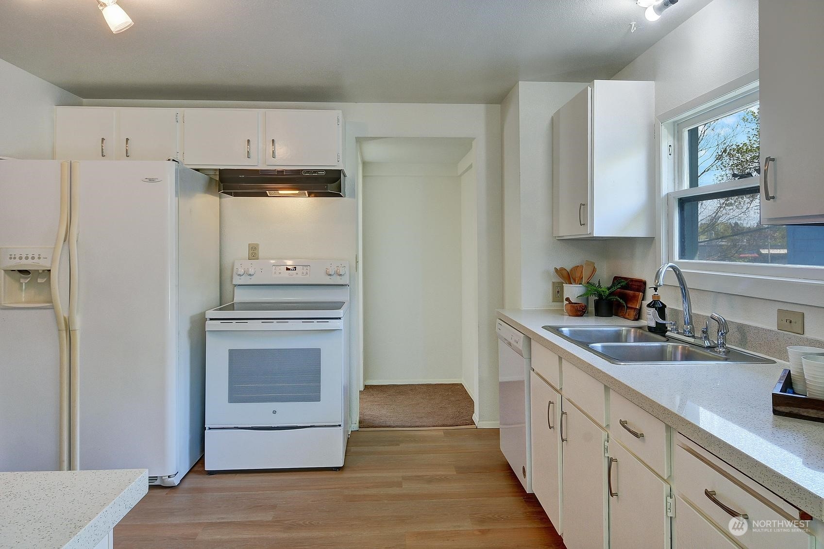 9448 18th Avenue Southwest Seattle, WA 98106 - Photo 11 of 20 a kitchen with granite countertop a refrigerator and a sink