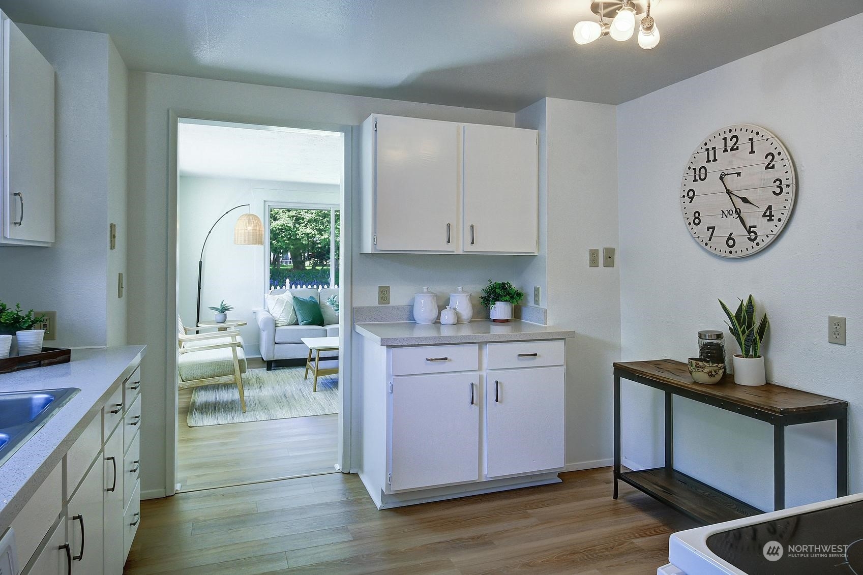 9448 18th Avenue Southwest Seattle, WA 98106 - Photo 10 of 20 a kitchen with sink cabinets and wooden floor
