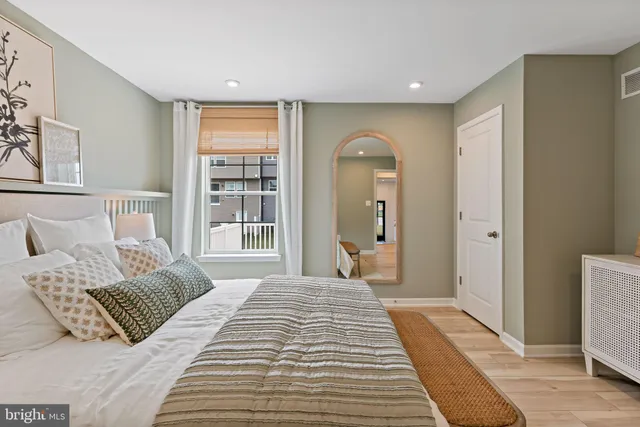 a bedroom with a large bed and a window