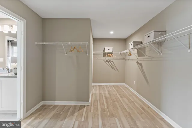 a view of a room with wooden floor