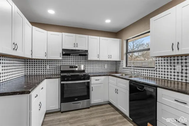 a kitchen with a sink stove and cabinets