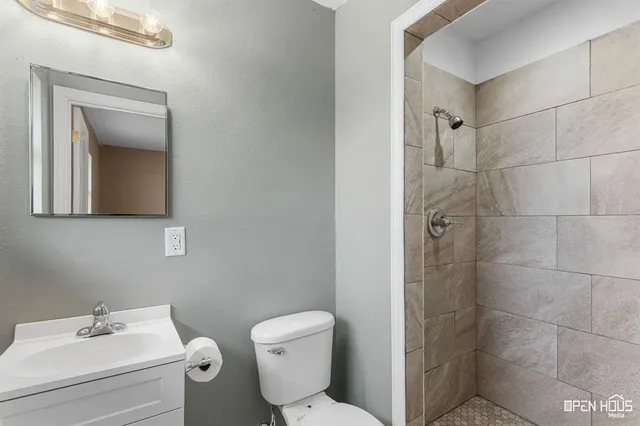 a bathroom with a toilet sink and shower