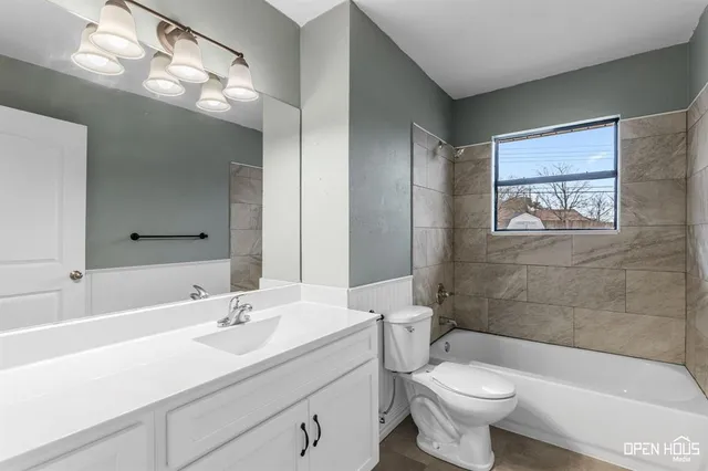 a bathroom with a double vanity sink toilet and shower