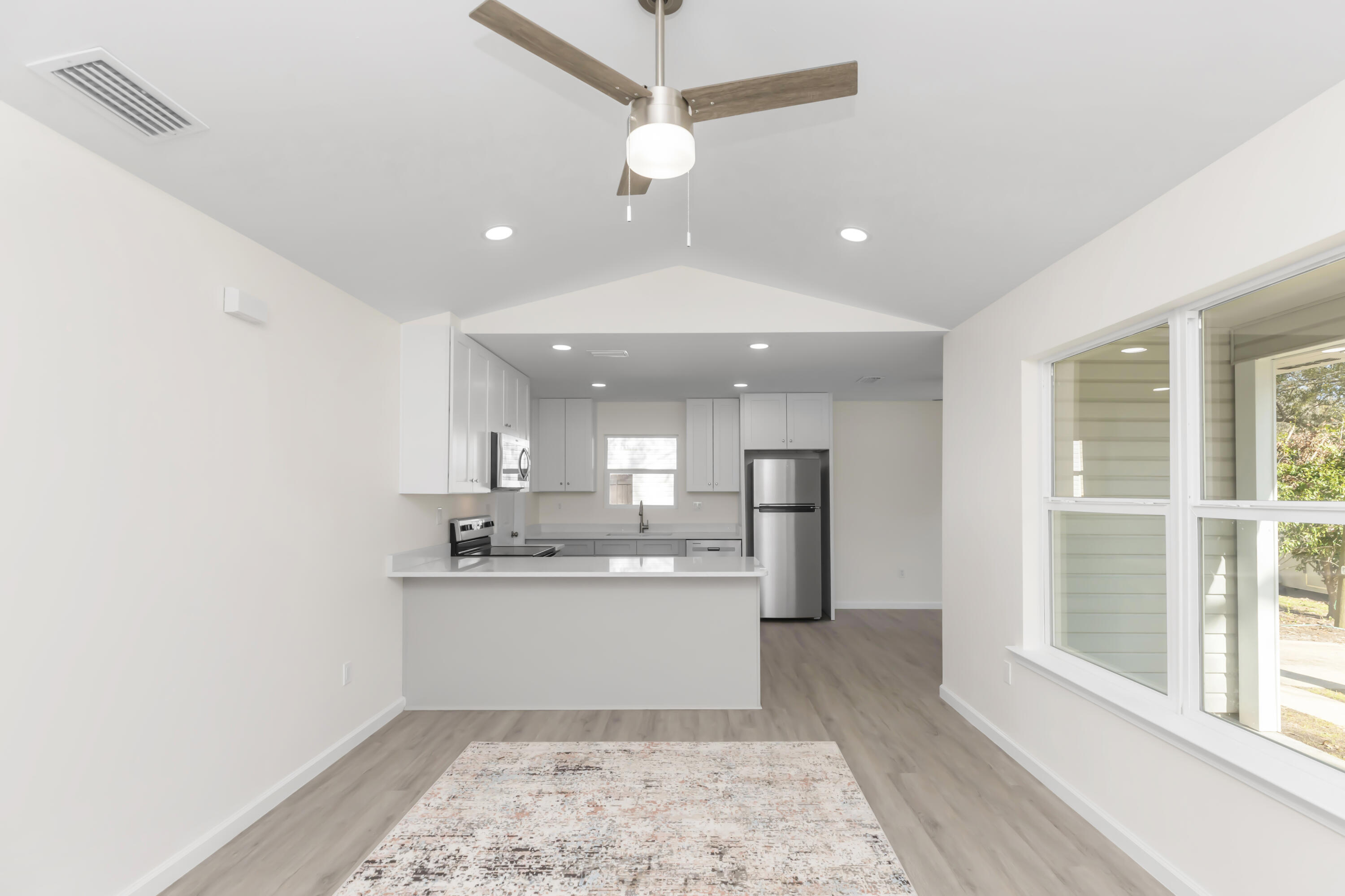105 Beacons Bend Road Crestview, FL 32536 - Photo 11 of 52 a kitchen with kitchen island a sink stainless steel appliances and cabinets
