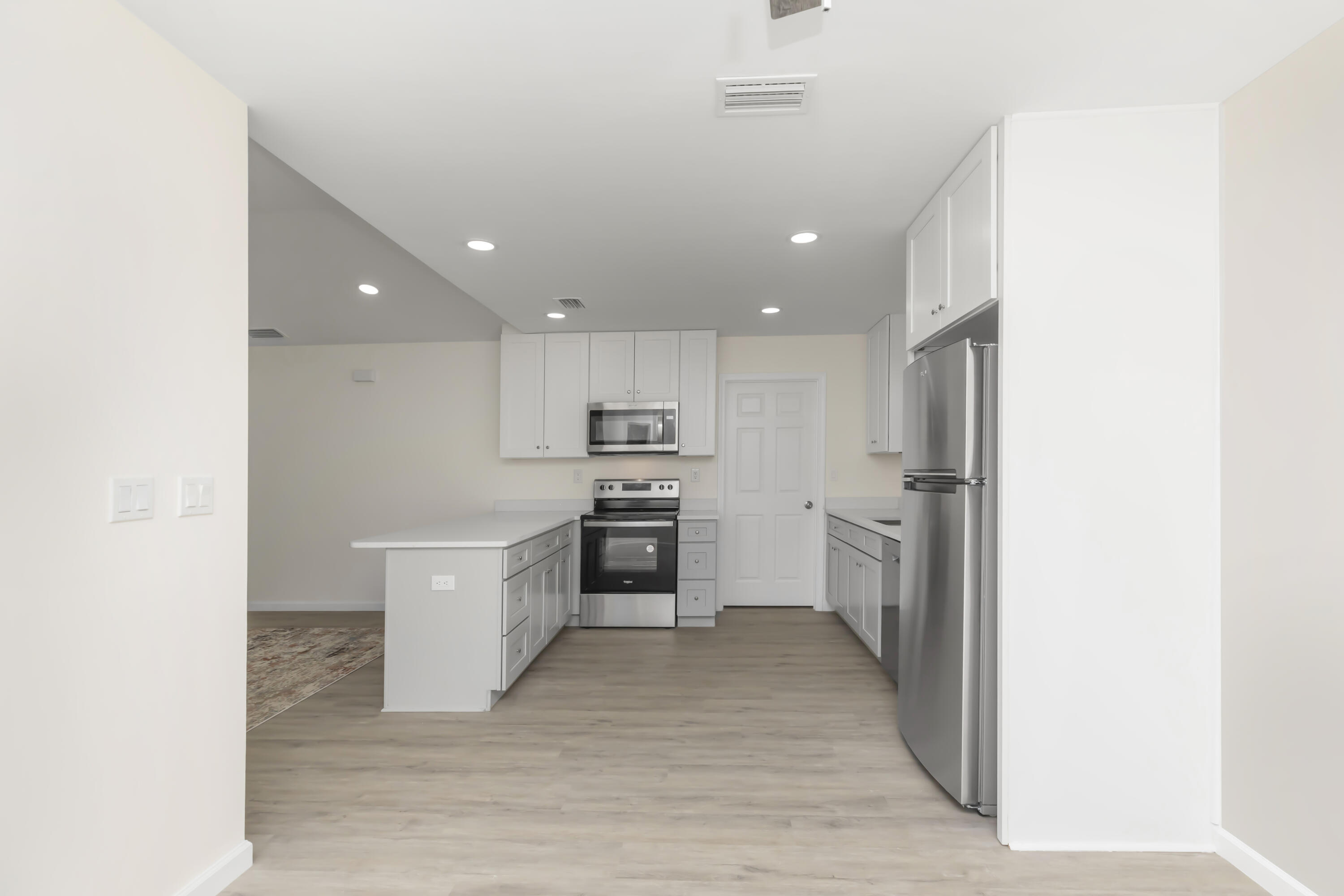 105 Beacons Bend Road Crestview, FL 32536 - Photo 14 of 52 a large kitchen with a center island and stainless steel appliances