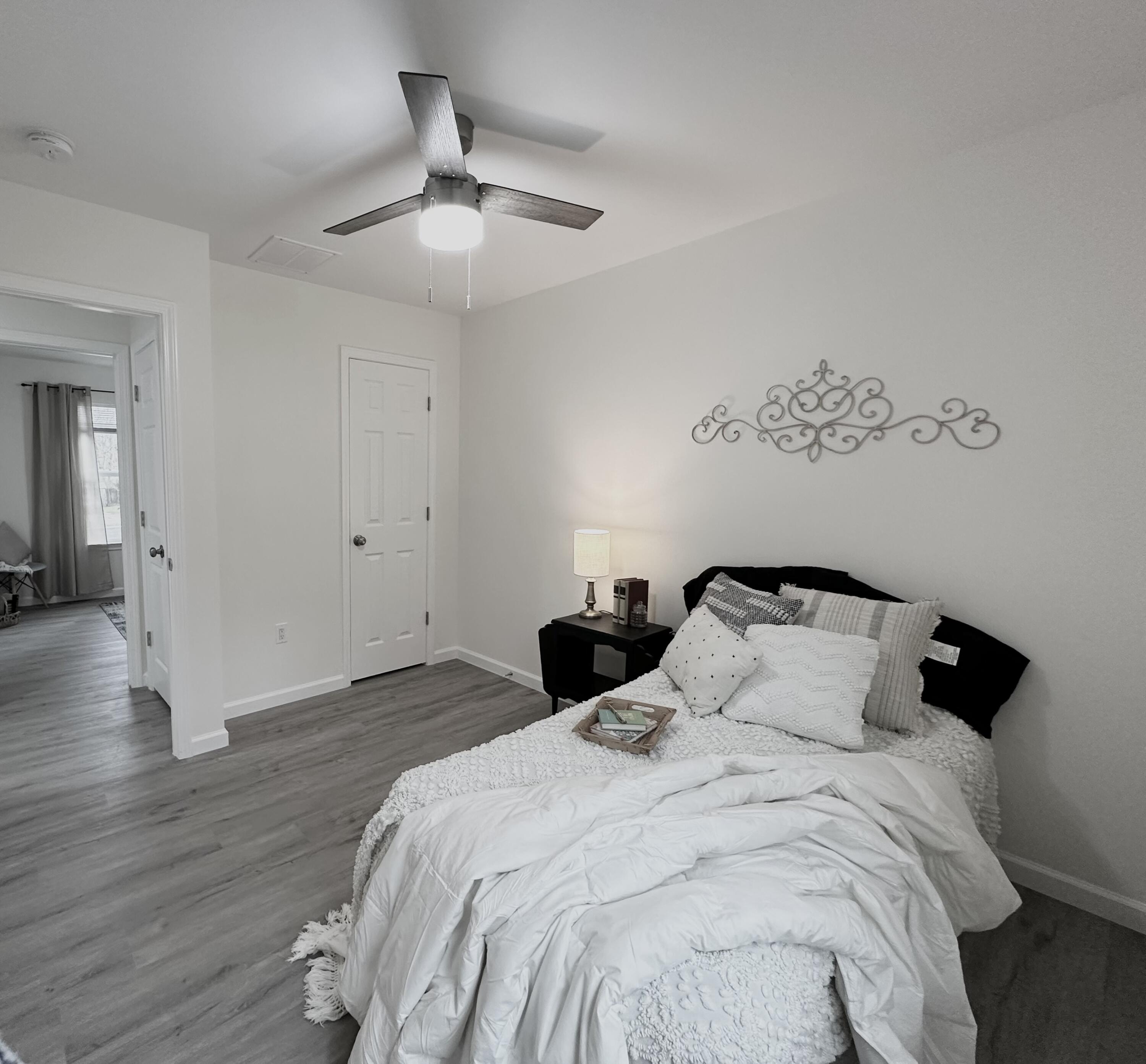 105 Beacons Bend Road Crestview, FL 32536 - Photo 19 of 52 a bedroom with a bed and wooden floor