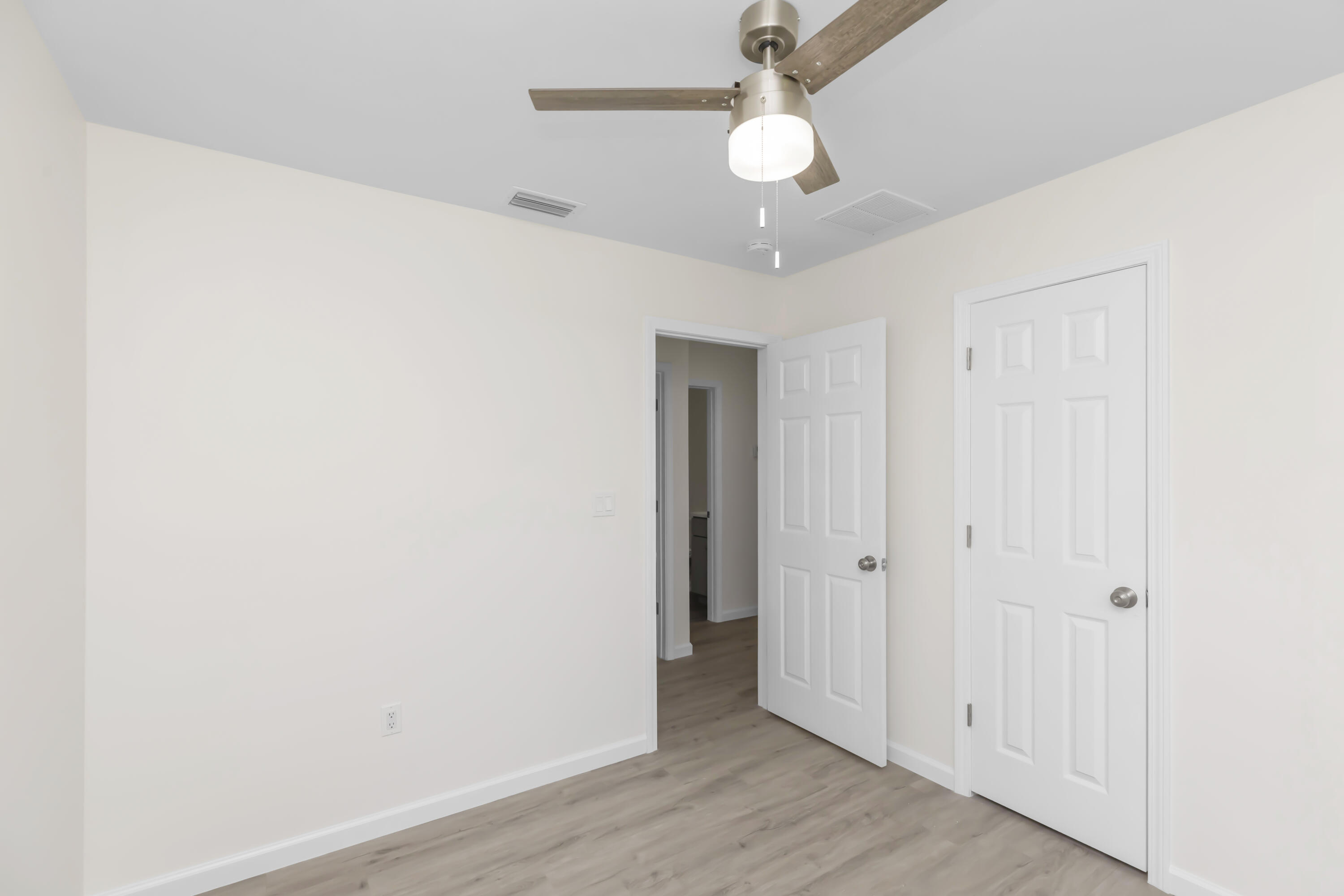 105 Beacons Bend Road Crestview, FL 32536 - Photo 23 of 52 an empty room with wooden floor