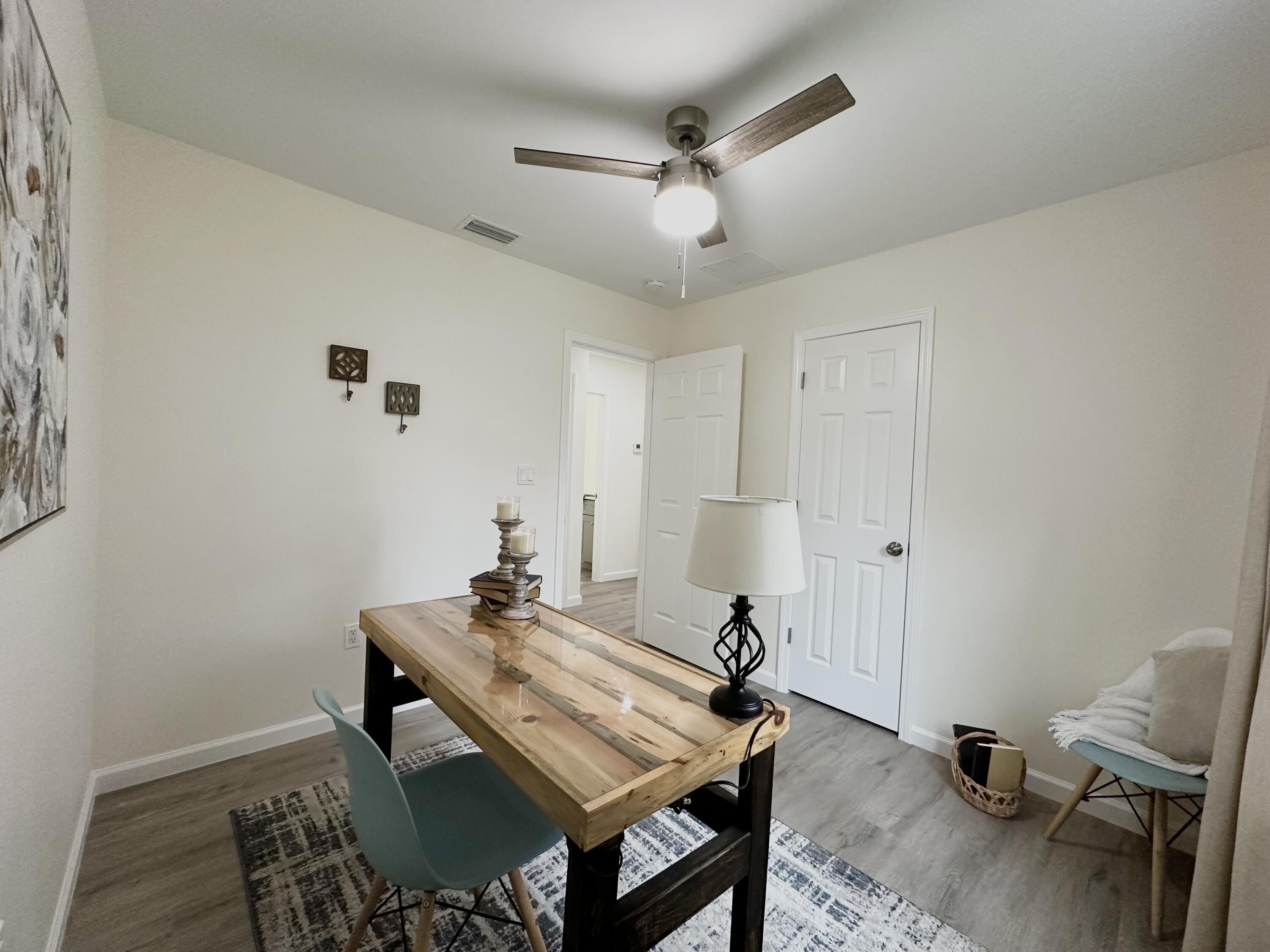 105 Beacons Bend Road Crestview, FL 32536 - Photo 25 of 52 a view of a workspace with furniture and wooden floor