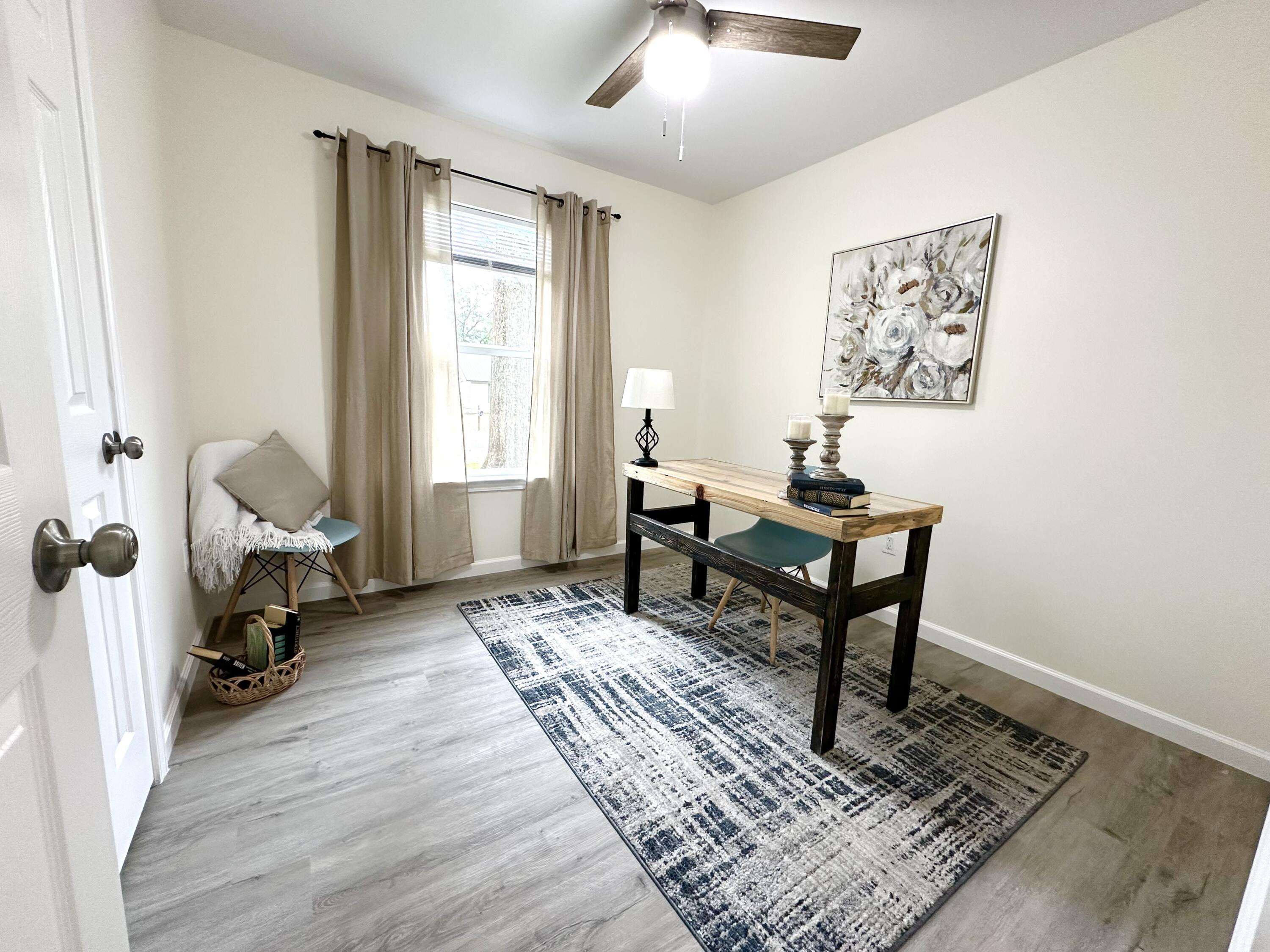 105 Beacons Bend Road Crestview, FL 32536 - Photo 26 of 52 a living room with furniture and a window
