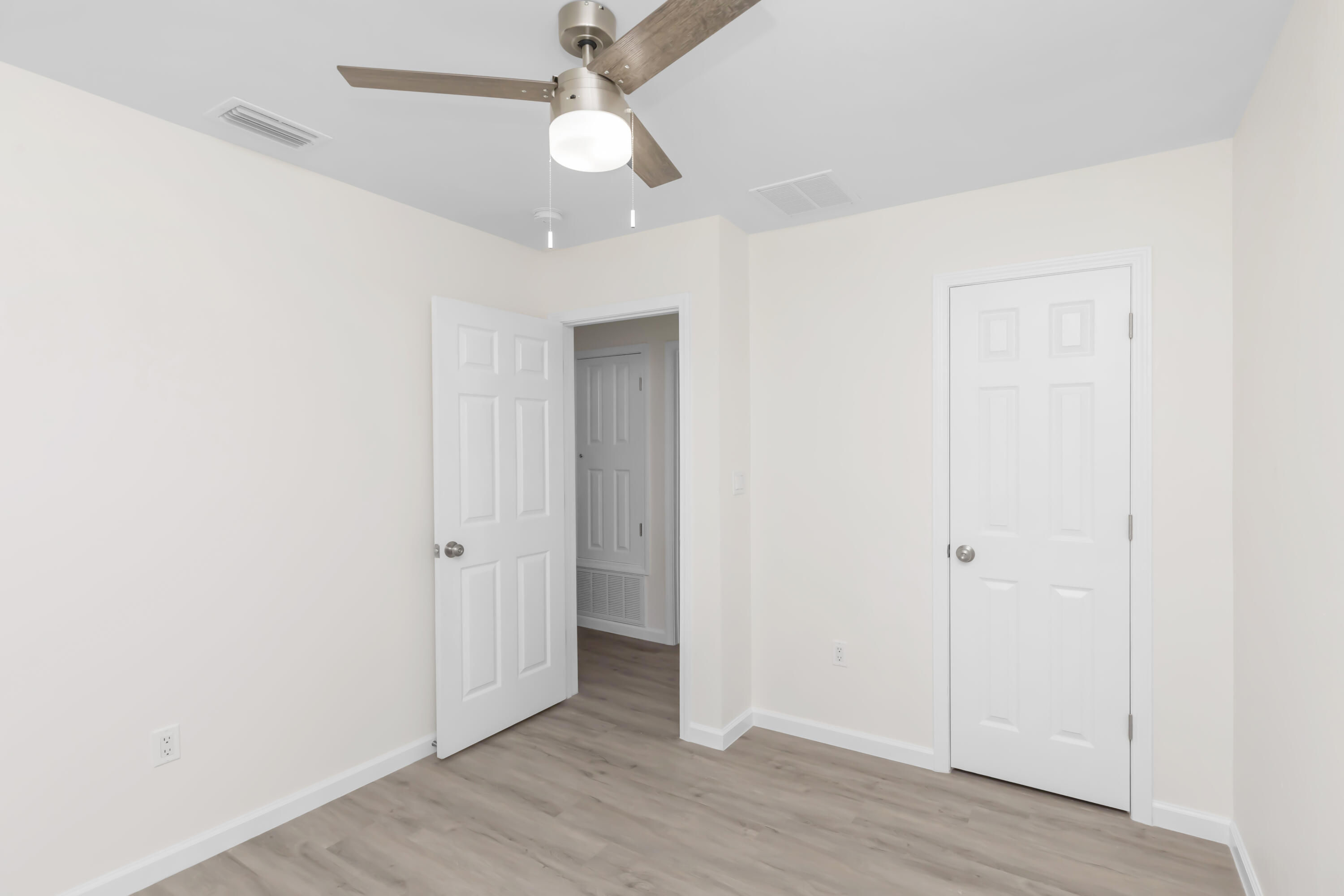 105 Beacons Bend Road Crestview, FL 32536 - Photo 29 of 52 an empty room with wooden floor and ceiling fan