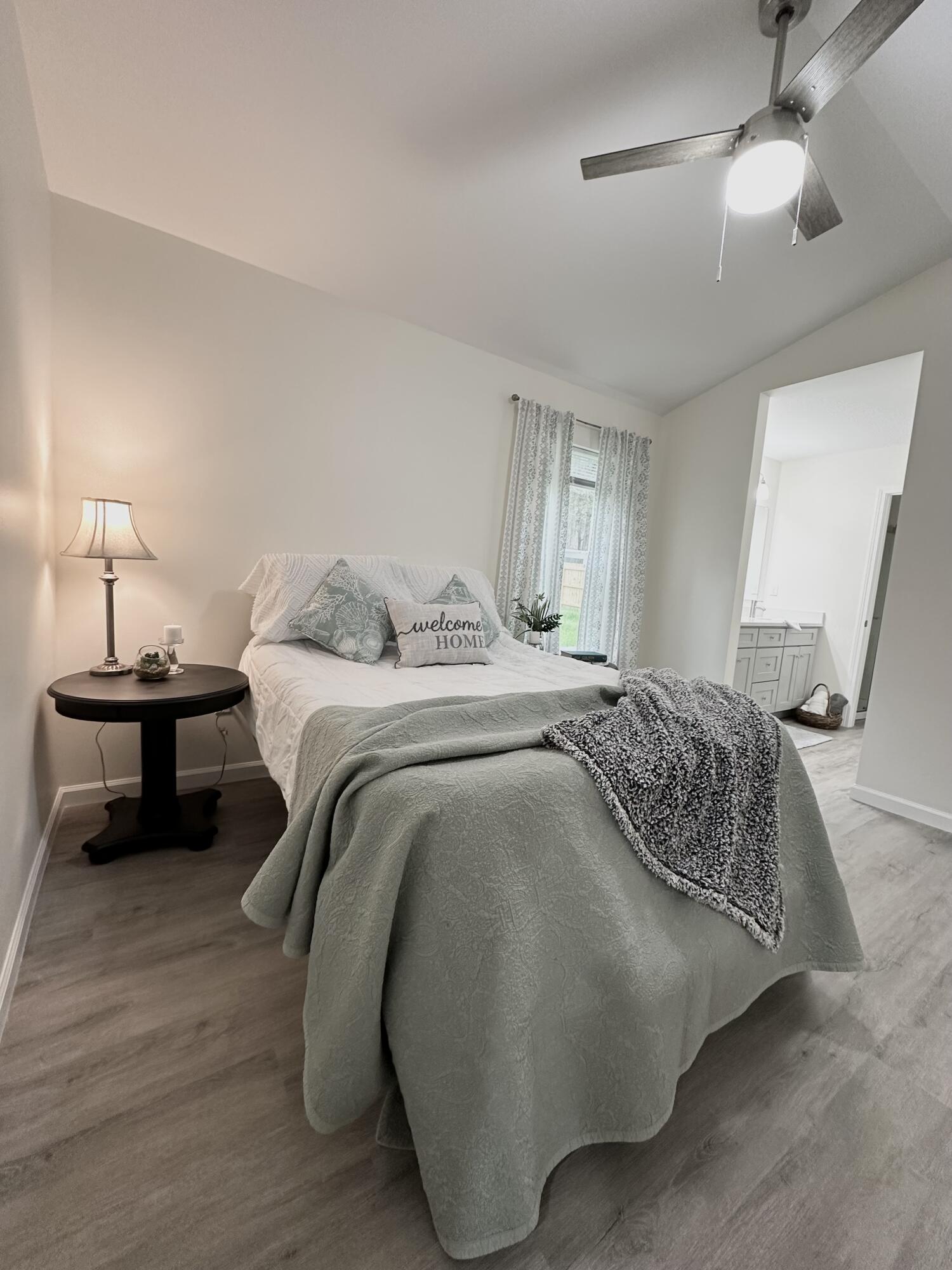 105 Beacons Bend Road Crestview, FL 32536 - Photo 35 of 52 a bedroom with a bed and a chandelier